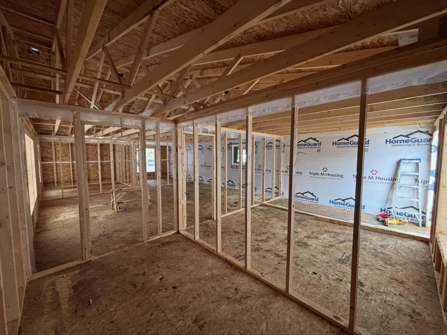 Interior framing for home addition showing framed bedrooms and salon layout in Sturgeon County