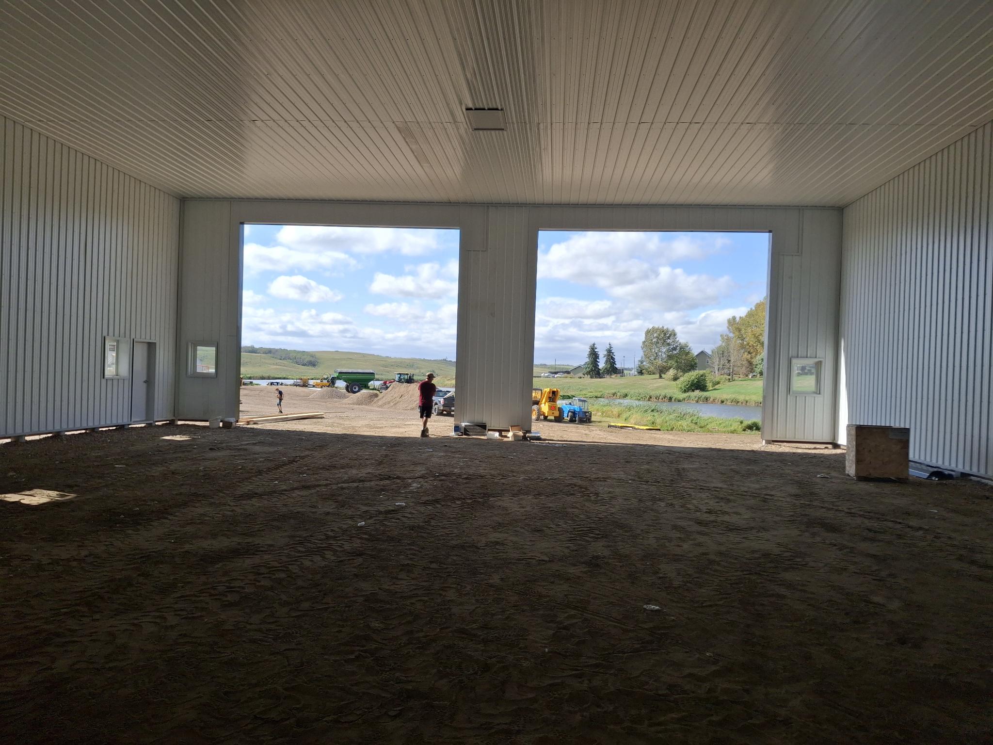 Open interior layout with multiple equipment access doors in an Alberta post-frame shop
